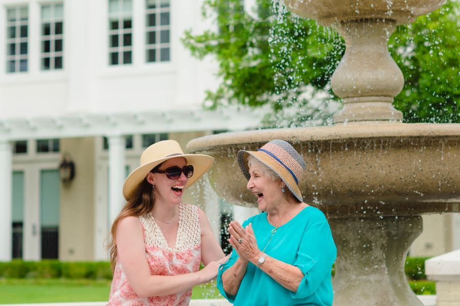 2 women in front of fountain