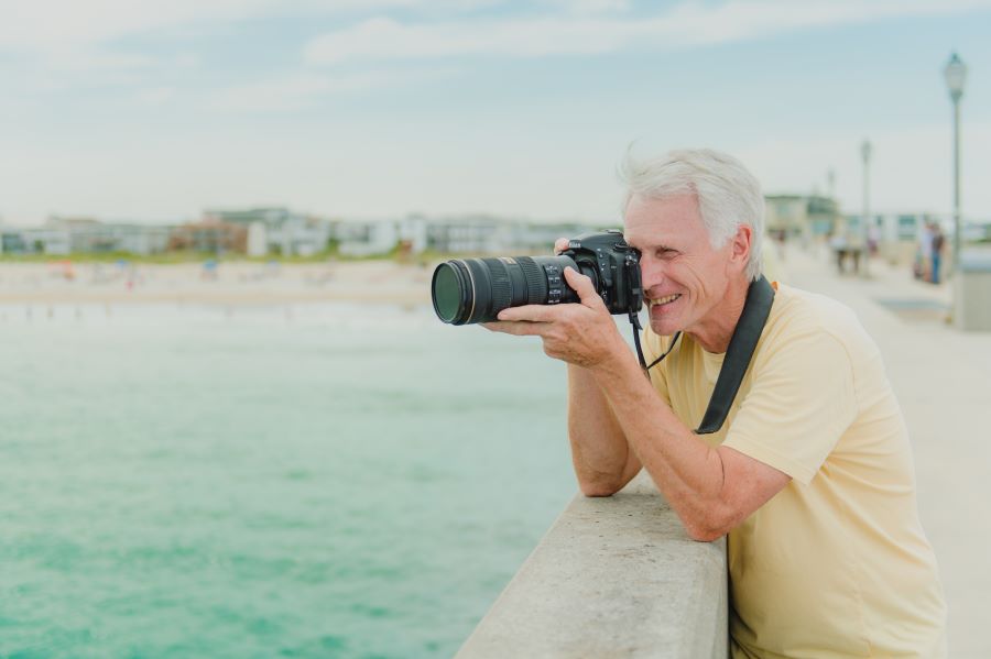 Senior man with camera