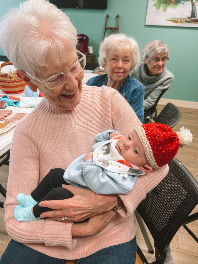 Senior woman with baby in Knotted Hat